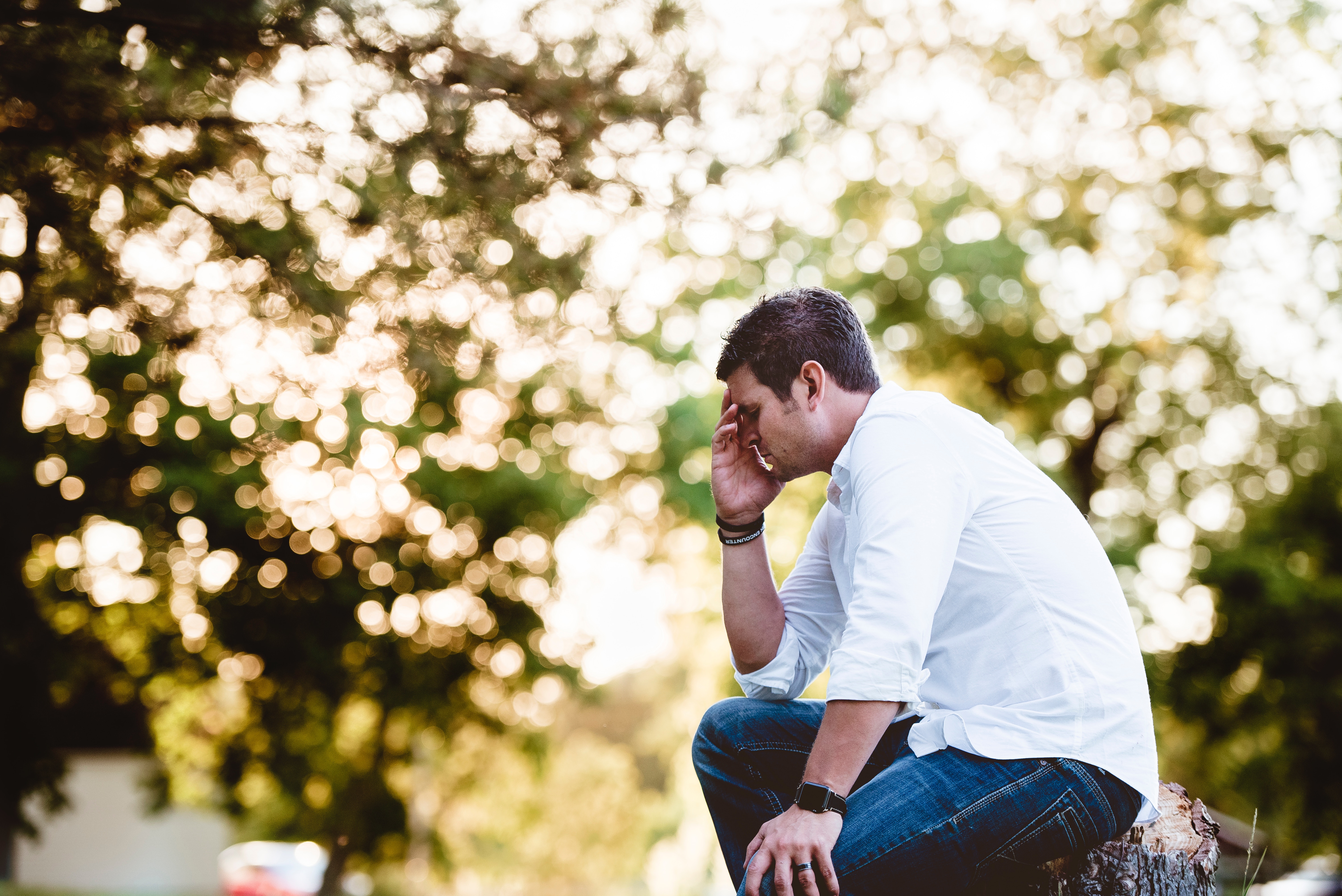 Man sitting with head in hand