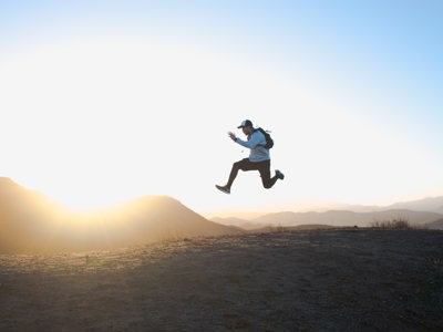 man jumping in air on mountain