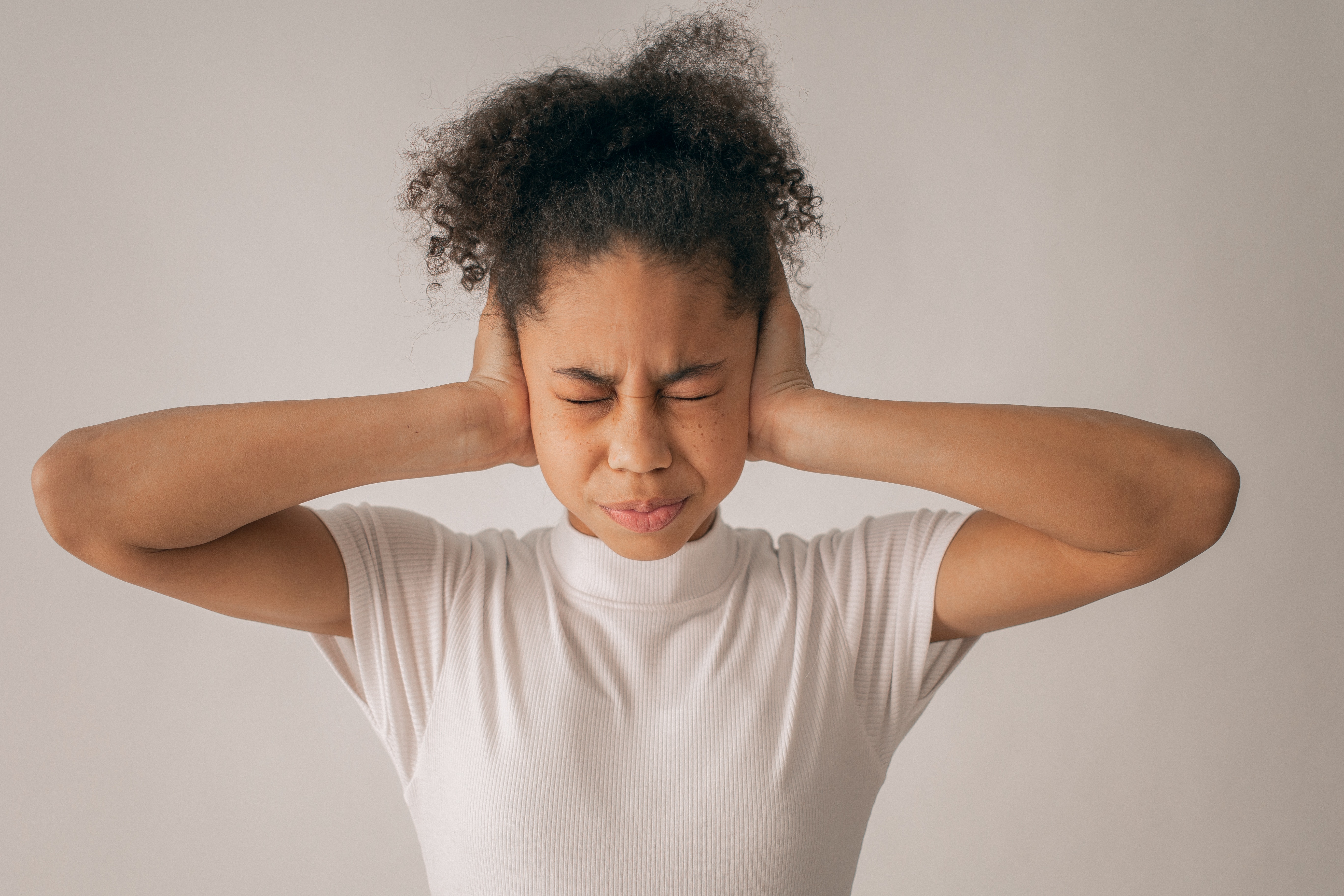 person covering ears eyes closed