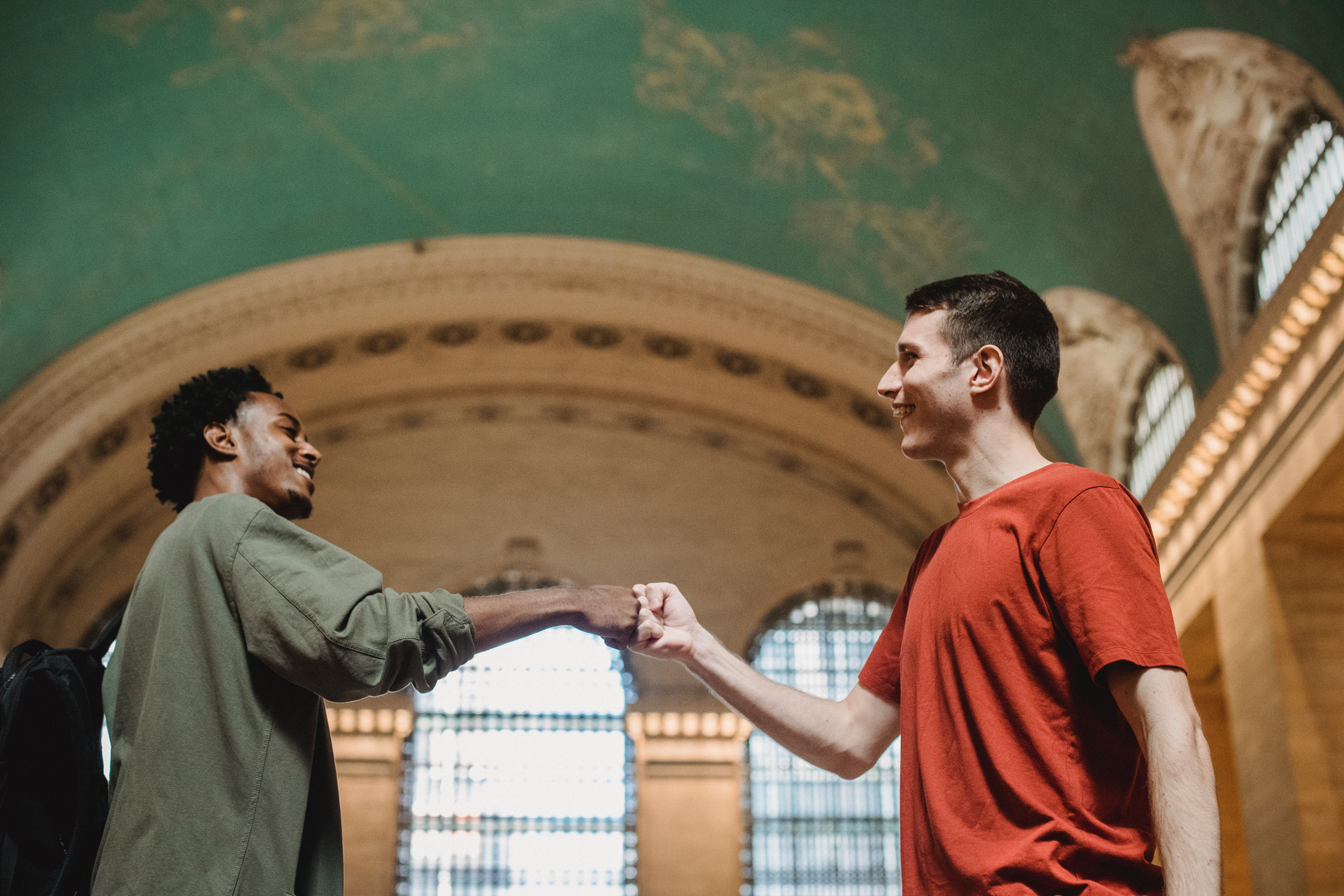 two men bumping fists together