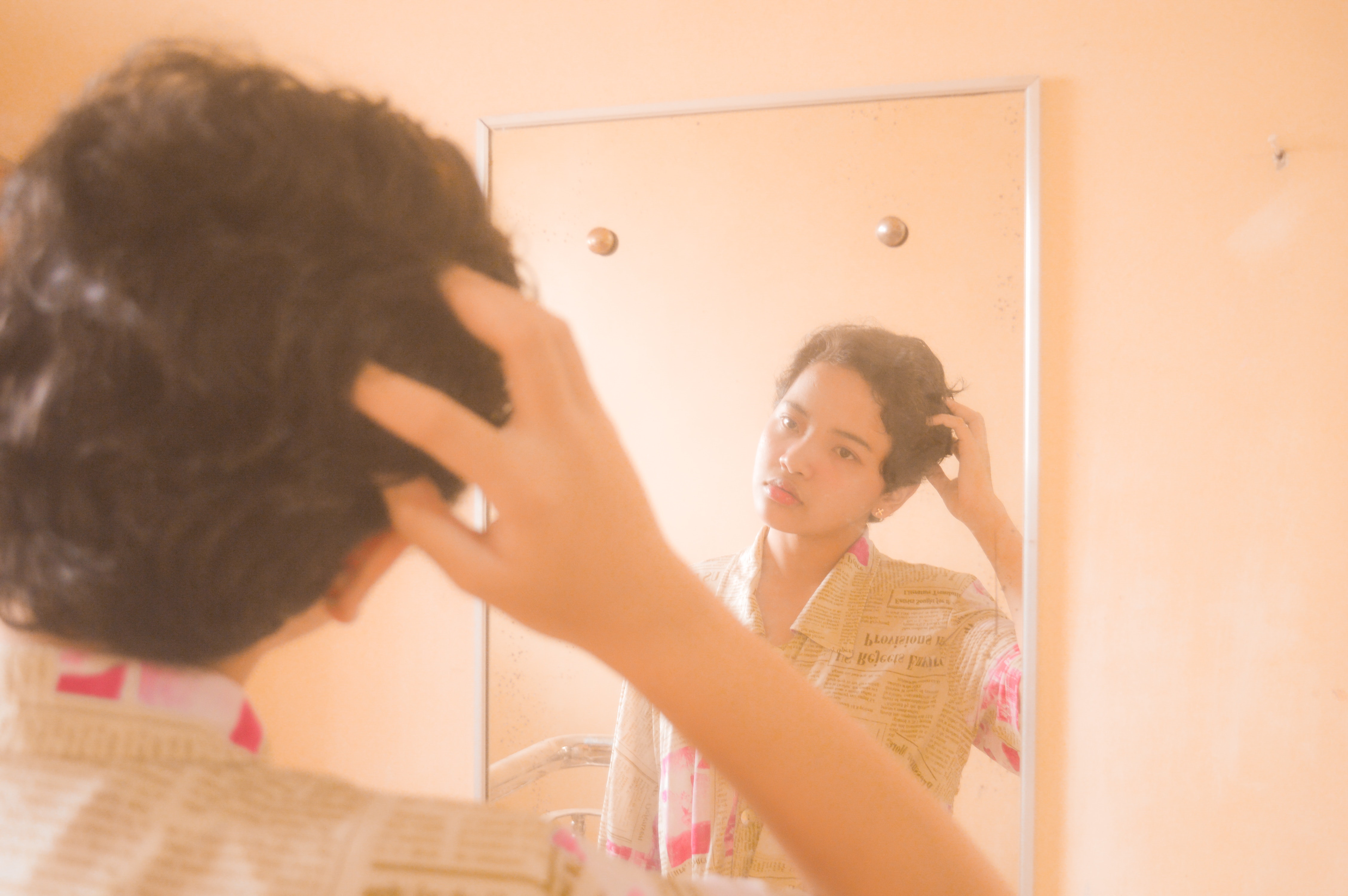 teen looking at themselves in mirror