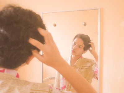 teen looking at themselves in mirror